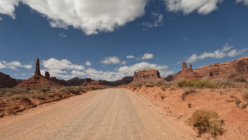 Valley of the Gods Utah desert towers POV. Scenic sandstone valley southeastern Utah desert landscape. Enchanting rock and stone natural formations. Camping, hiking, exploring adventure. Royalty-Free Stock Footage #1090267457