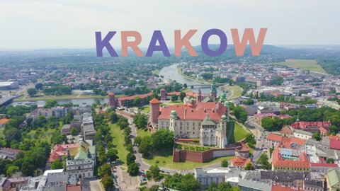 Inscription on video. Krakow, Poland. Wawel Castle. Ships on the Vistula River. View of the historic center. Multicolored text appears and disappears, Aerial View, Point of interest