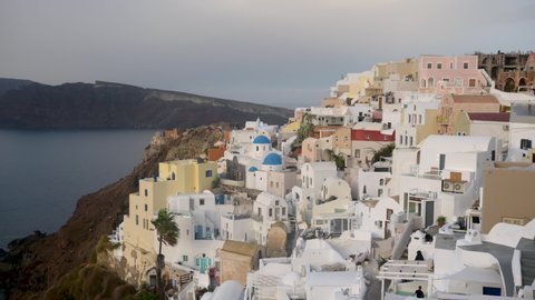 Beautiful panorama on the famous Oia village in Santorini. Traditional whitewashed houses on the edge of a volcanic caldera on the island of Santorini in Greece.
