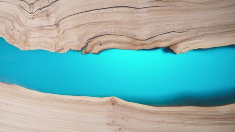 Beautiful surface of a wooden slab tabletop filled with epoxy resin.