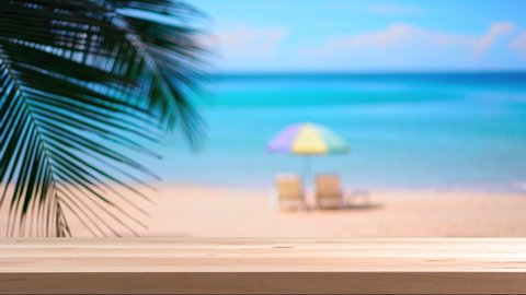 Wooden table top with blurred tropical beautiful white sand beach, Summer vacation concept and copy space