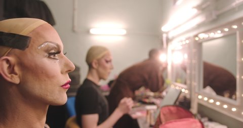 Group of Drag Queens Applying Make up Backstage, looking in Mirror Stockvideó