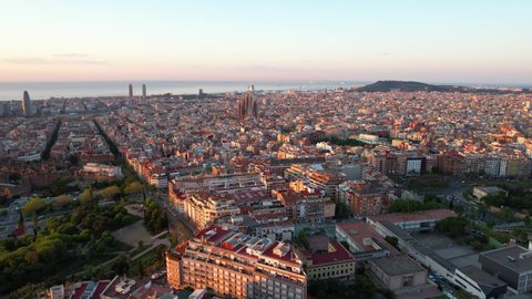 Aerial view of Barcelona and Sagrada Familia Cathedral at sunrise. Eixample residential famous urban grid. Catalonia, Spain