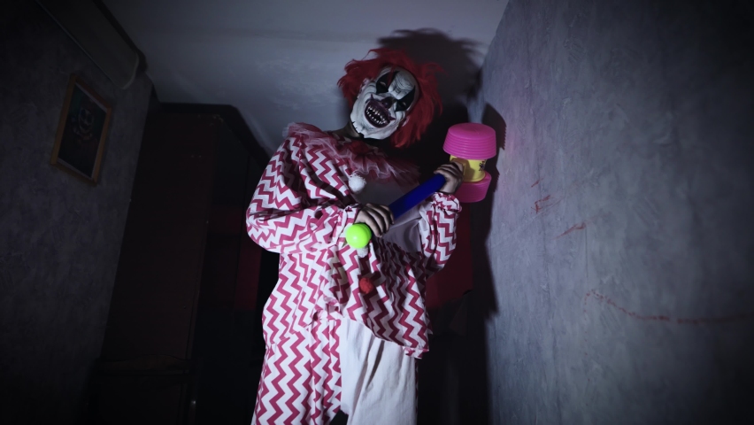 Creepy and evil clown, in a gloomy and abandoned room. | Shutterstock HD Video #1090276269
