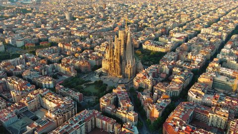 Aerial view of Barcelona Eixample residential district and Sagrada Familia Basilica at sunrise. Catalonia, Spain