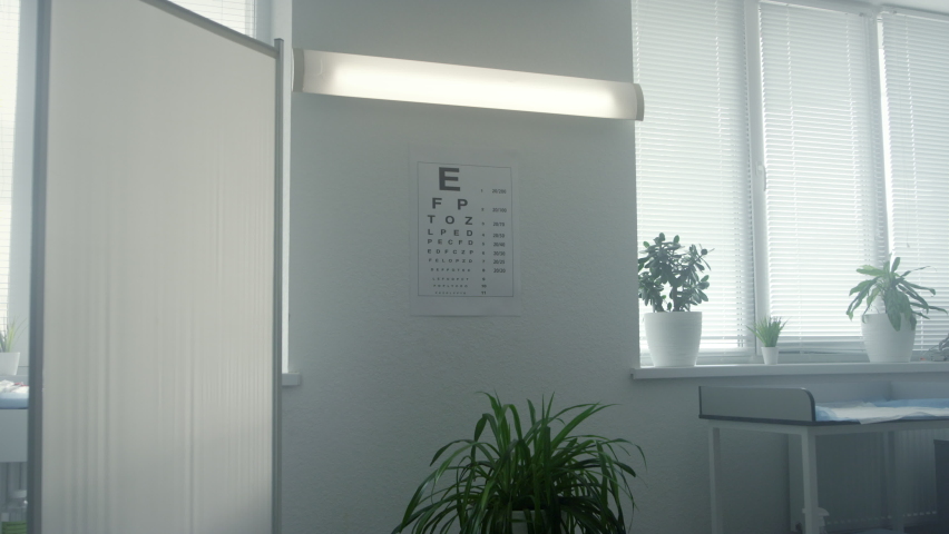 Standard eyesight test chart hanging white wall in doctor office closeup. Bigger smaller alphabet for eye examination in cabinet. Optometry poster for checking vision disease in ophthalmologist clinic Royalty-Free Stock Footage #1090279025