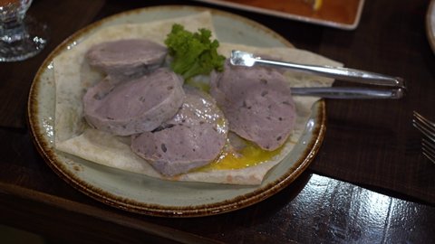 Armenian dish kyufta. slices of boiled minced beef "Kyufta" in restaurant. This meat dish  is very common in the Caucasus. Traditional dish meat Kufta with Hachar. 