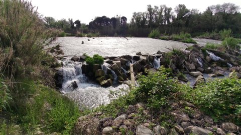 4k video of the Urdan weir in the town of San Juan de Mozarrifar, a day of hiking through nature, a landscape near the city of Zaragoza, Aragon. Spain, full of vegetation, flowers and water.
