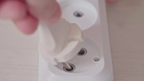 Male Hand Plugs In The Plug In Socket Electric Extension Cord And Turn On The Power Switch. Inserting the plug into the socket. High quality 4k footage