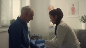 Senior man visit cardiologist in health clinic close up. Latino woman doctor preparing elderly patient for medical examination hospital. Therapist check pensioner pulse. Healthcare old people concept - Powered by Shutterstock - Get 15% off with code: PIKWIZARD15