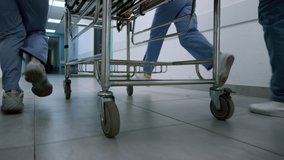 Doctors feet running down hospital corridor with gurney close up. Unknown medics team moving quickly to emergency room. Medical professionals pushing stretcher hurrying on operation. Health concept. - Powered by Shutterstock - Get 15% off with code: PIKWIZARD15