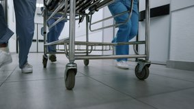 Medics legs running down hospital corridor rolling gurney to emergency room close up. Unknown medical professionals hurrying clinic hallway steering stretchers for patient. Healthcare concept. - Powered by Shutterstock - Get 15% off with code: PIKWIZARD15