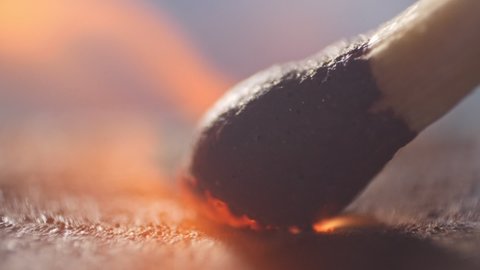 Extreme close up of a match lights in slow motion. Macro shot of a matchbox