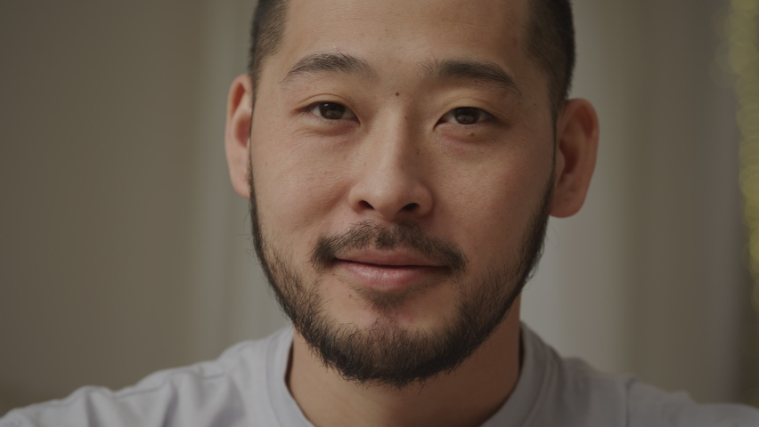 Close up portrait of a young adult asian man smiling at camera indoors | Shutterstock HD Video #1090291915
