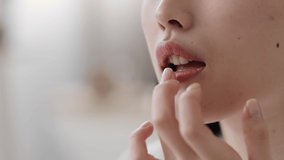 Beauty care and moisturizing. Close up shot of unrecognizable lady applying pampering lotion or balm on lips, slow motion, empty space - Powered by Shutterstock - Get 15% off with code: PIKWIZARD15
