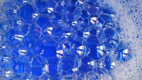 Blue background with soap bubbles on the water surface