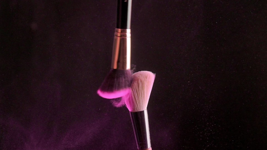Two makeup brushes with powder on a dark background | Shutterstock HD Video #1090293607