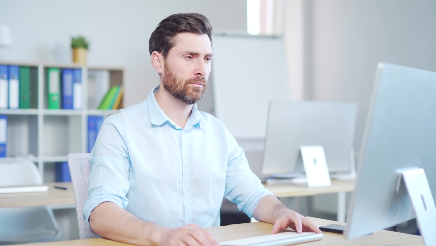 Young handsome bearded caucasian man employee with severe toothache. male worker indoors suffers from Strong pain. Sitting at work in workplace office. painful expression dental illness on teeth Royalty-Free Stock Footage #1090295333