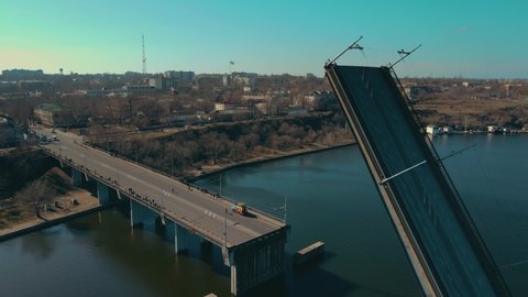 Cinematic shot raised drawbridge through river South Bug in Nikolaev Ukraine few days before start of war. Concept of logistics of roads and waterways