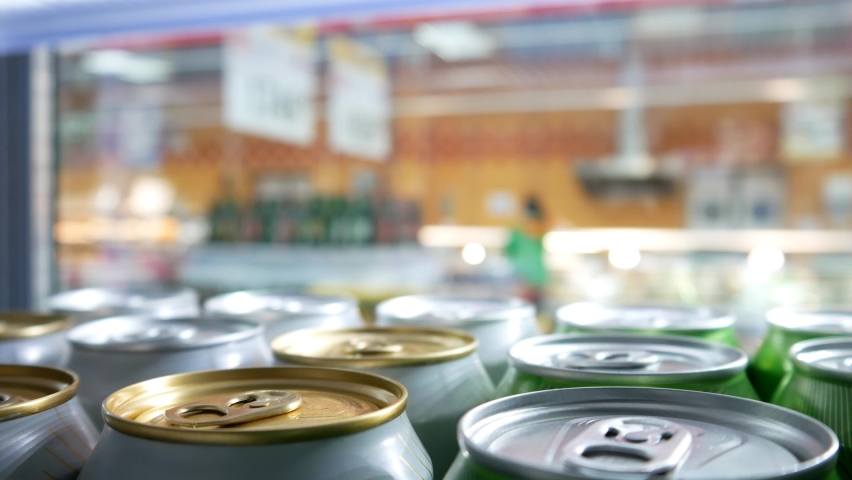 Close-up of cold beer or soda cans and a man opens the refrigerator and takes one Royalty-Free Stock Footage #1090296435
