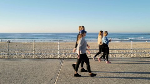 Sydney, Australia, May 2022-People walking at Bondi beach in the morning