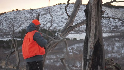 Two hunters observe the movement of deer on a hunting activity in winter. outdoor activities. the process of killing game.
