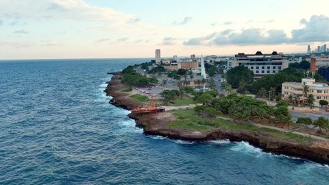Malecon of Santo Domingo with obelisk in Center of Heroes park, Dominican Republic. Aerial drone shot forward