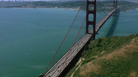aerial top down view of cars crossing the famous Golden Gate Bridge in San Fransisco California USA during a sunny summer day