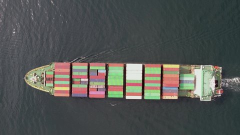 Large container ship at sea -Top down view.  Aerial top view of cargo container ship vessel import export container sailing.