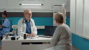 General practitioner and patient analyzing covid 19 virus animation on laptop, talking about prevention and recovery in medical office. Doctor using coronavirus illustration on screen. - Powered by Shutterstock - Get 15% off with code: PIKWIZARD15