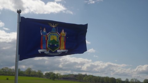 Flag of New York state, region of the United States, waving at wind