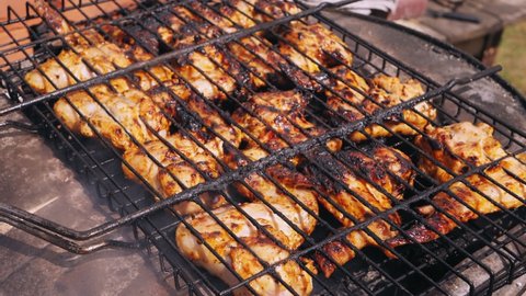 marinated chicken wings grilled over charcoal grill. Medium plan