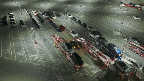 Tesla factory, Fremont, USA. Feb. 2022. Drone shot shows Tesla Gigafactory in California at night. EV sedans loaded on a carriages after testing as seen from above. High quality 4k footage