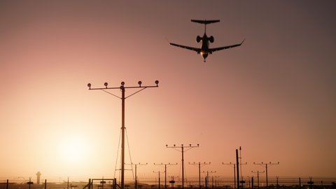 Holiday vacation tourism concept video. Back view airplane with tourists landing in airport at night. Tourism cinematic sunset at airport, 6K travel footage Scenic pink sunset sky on summer evening