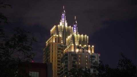 night time illumination bangkok city downtown towers top running clouds panorama 4k timelapse thailand