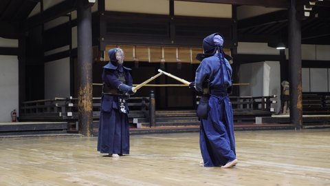 Kyoto, Japan - April 23, 22: Kendo practice in Dojo. Kendo warrior practicing martial art with the bamboo bokken. High quality 4k footage