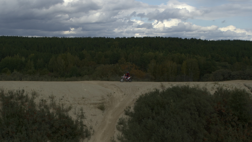 Enduro motorcycle rides off-road on the sands
