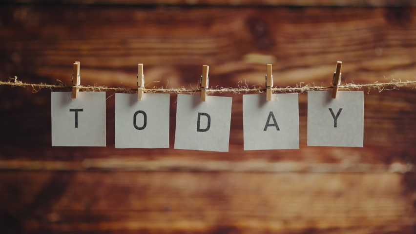 The word today. Letters on cards on wooden background. Concept of lettering and text or phrase.