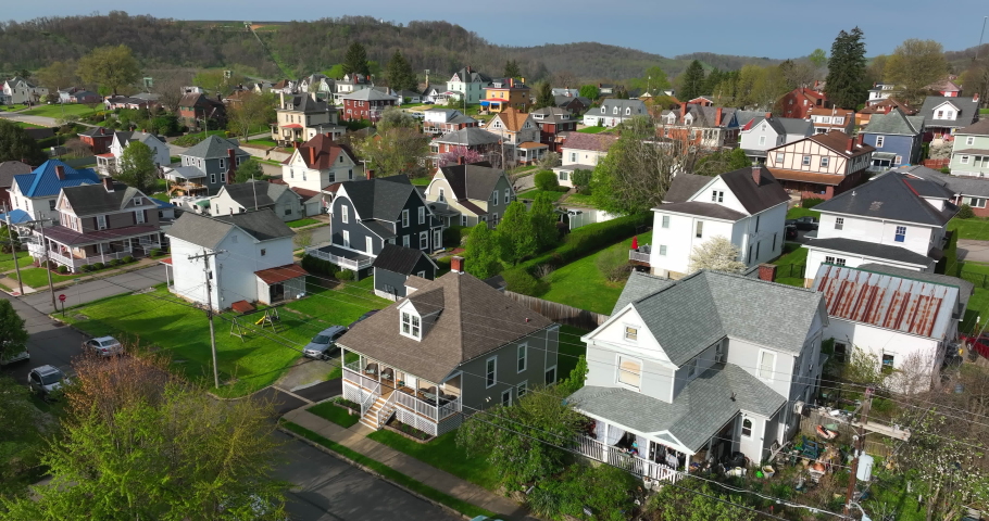 Coal mining town. Rising aerial reveals mine in distance. Housing in small neighborhood community in rural Appalachian Mountains. | Shutterstock HD Video #1090310815