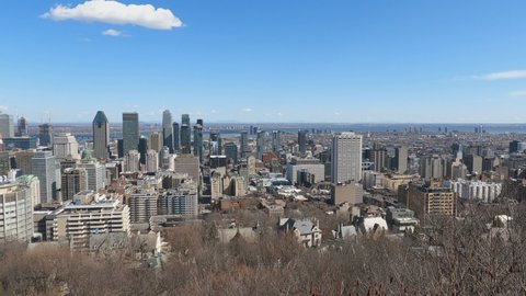 Montreal, Quebec, Canada - April 12, 2022: View of the skyline of Montreal from the Kondiaronk Belvedere overlook at Mont-Royal Park