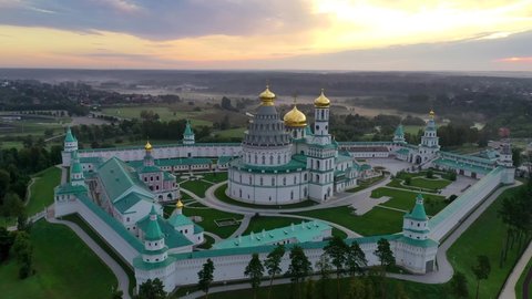 Istra, Moscow Oblast, Russia - August, 2021: Holy places of the country. Aerial footage of New Jerusalem Monastery on foggy morning.
