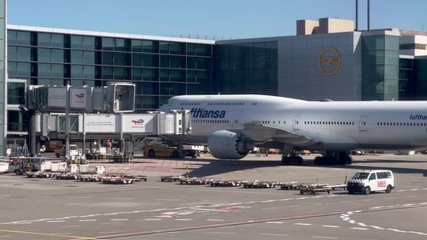 Frankfurt, Germany - April 18 2022: A Lufthansa Boeing 747-8 parked at the Frankfurt Airport terminal building