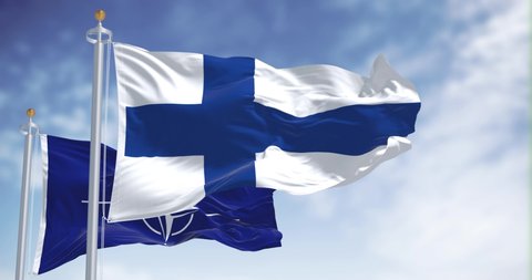 Helsinki, Finland, May 2022: The national flag of Finland waving along with the flag of NATO. In 2022 Finland asked to enjoy NATO after decades of neutrality