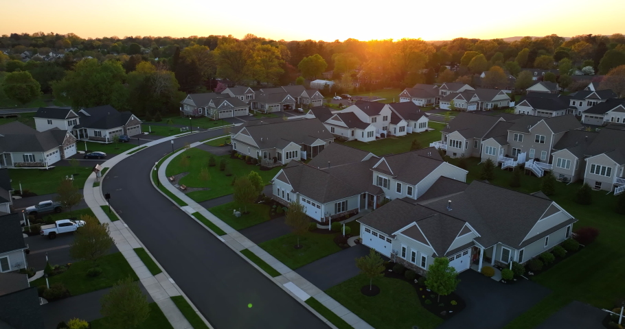 Residential property taxes theme. Homes and real estate new construction build in USA. Aerial at sunset. Royalty-Free Stock Footage #1090317035