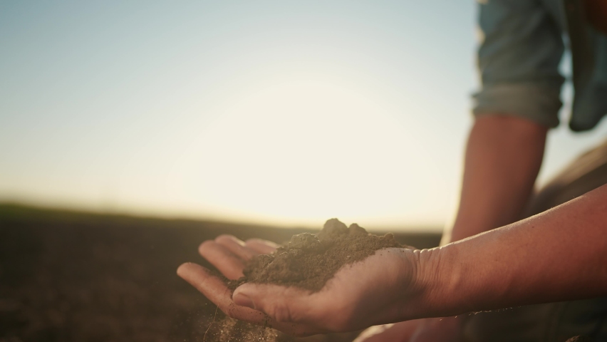 soil in the hands of the farmer. agriculture. close-up of a farmers hands holding black soil in their hands, fertile land. garden field ground sun fertile concept. worker holding soil plowed field Royalty-Free Stock Footage #1090318219