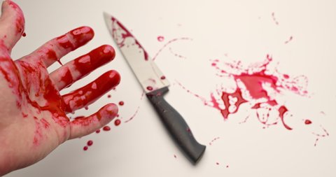 Blood stained knife against white isolated background
