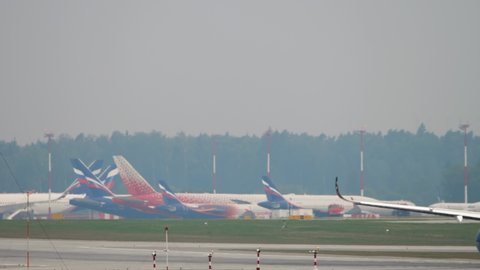 MOSCOW, RUSSIAN FEDERATION - JULY 30, 2021: Airbus A350 of Aeroflot picking up speed on the runway before takeoff at Sheremetyevo airport (SVO). Rear view, airliner flying away, departure