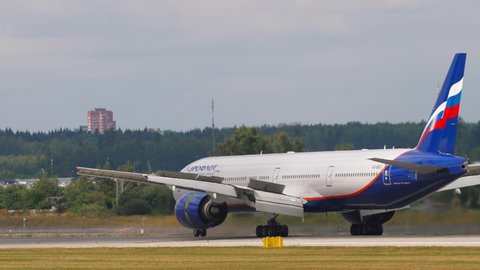 MOSCOW, RUSSIAN FEDERATION - JULY 29, 2021: Civil aircraft Boeing 777 Aeroflot braking after landing with raised flaps at Sheremetyevo airport (SVO). Tourism and travel concept.