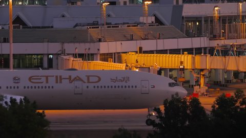 PHUKET, THAILAND - NOVEMBER 26, 2019: Boeing 777 of Etihad Airways taxiing to the terminal after landing at Phuket airport in the evening. Huge passenger plane arriving at the airport in the evening