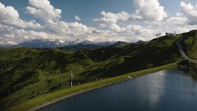 The beautiful aerial drone footage of the green Alps and Leogang Lake  Austria 